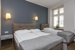 Posteľ alebo postele v izbe v ubytovaní Hotel Floryan Old Town