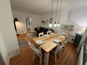 a dining room and living room with a table and chairs at Stirling Haven: Charming 3B Apt in City Centre in Stirling +19 photos