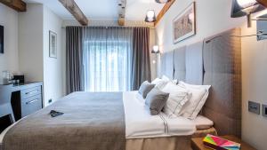 Postel nebo postele na pokoji v ubytování Michaelson Boutique Hotel & SPA Brícoła