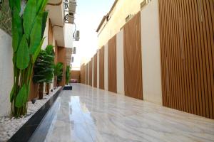 an empty hallway of a building with plants at استديو انيق بـ دخـول ذكي in Riyadh
