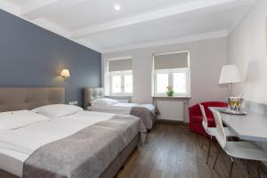Posteľ alebo postele v izbe v ubytovaní Hotel Floryan Old Town