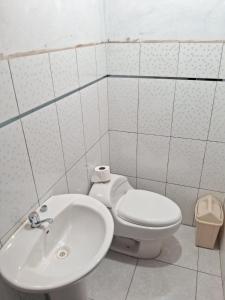 a bathroom with a toilet and a sink at Guest House Aylluq Wasin in Urubamba