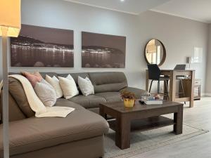 a living room with a couch and a table at Oasis Apartment by Sesimbra Sun Sea in Sesimbra