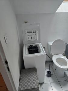a small bathroom with a toilet and a sink at Charmant appart T2 tout équipé in Montbéliard