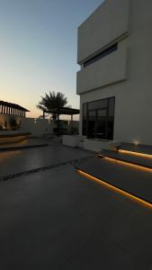 a building with yellow lights in front of it at Private Pool Villa Rawaq Chalet in Āsam