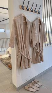 a towel hanging on a wall next to a pair of shoes at Private Pool Villa Rawaq Chalet in Āsam +72 photos