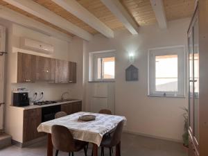 a kitchen with a table and chairs in a room at Palazzo Umberto in Montauro
