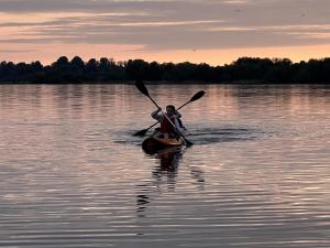 a person in a kayak on a body of water at Lough Derg Holidays in Mountshannon +3 photos