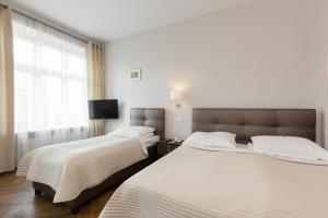 Posteľ alebo postele v izbe v ubytovaní Hotel Floryan Old Town