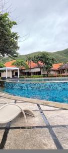 a large swimming pool with a resort at Bungalows in Sekongkang