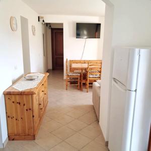 a kitchen with a white refrigerator and a table at La Casa del Sole in Carrodano Inferiore +23 photos