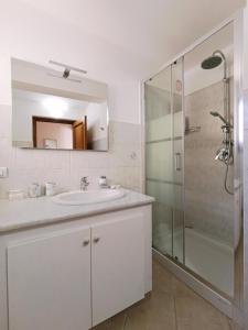 a bathroom with a sink and a shower at La Casa del Sole in Carrodano Inferiore