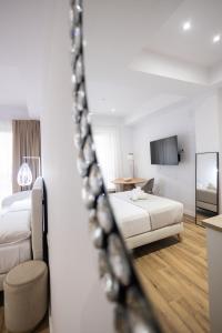 Postel nebo postele na pokoji v ubytování Lôla Suites by Concept Flats