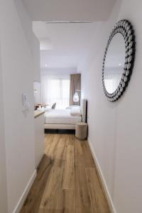 Postel nebo postele na pokoji v ubytování Lôla Suites by Concept Flats