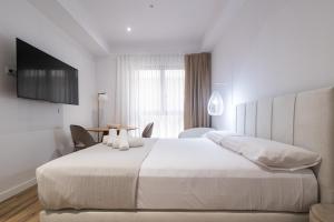 Postel nebo postele na pokoji v ubytování Lôla Suites by Concept Flats