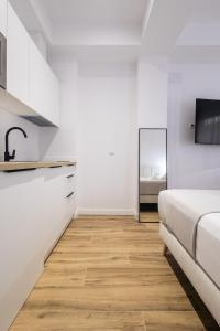 TV a/nebo společenská místnost v ubytování Lôla Suites by Concept Flats