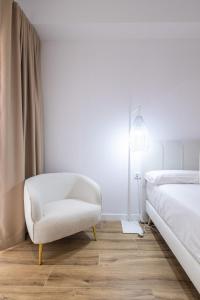 Postel nebo postele na pokoji v ubytování Lôla Suites by Concept Flats