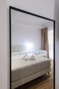 Postel nebo postele na pokoji v ubytování Lôla Suites by Concept Flats