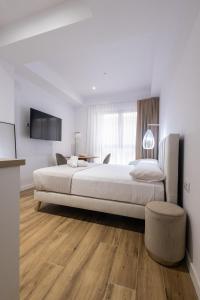 Postel nebo postele na pokoji v ubytování Lôla Suites by Concept Flats