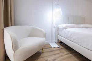 Postel nebo postele na pokoji v ubytování Lôla Suites by Concept Flats