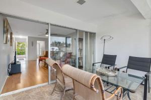 a living room with a glass table and chairs at Sandy Waves in Naples +10 photos