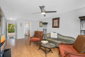 a living room with a couch and two chairs at Sandy Waves in Naples