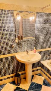 a bathroom with a sink and a mirror and a tub at Cabana Fersan in Cabanas de Tavira +16 photos