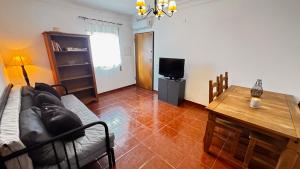 a living room with a couch and a table at Cabana Fersan in Cabanas de Tavira