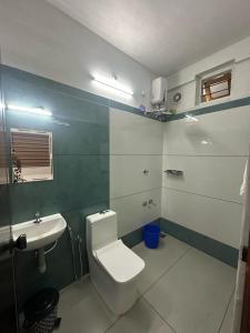 a bathroom with a toilet and a sink at Heaven meadows Homestay in Vagamon