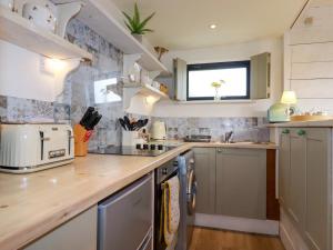 a kitchen with a counter top and a sink at The Cow Shed in Wadebridge