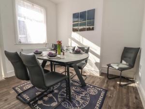 a dining room with a table and chairs at 23 Dock Road in Lytham St Annes