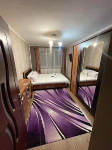 a small room with a bed and a mirror at Home away from home in Sighetu Marmaţiei