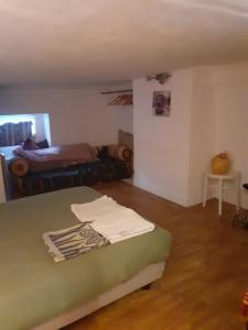 a bedroom with a bed and a living room at appartement 2 chambres à Lésigny in Lésigny