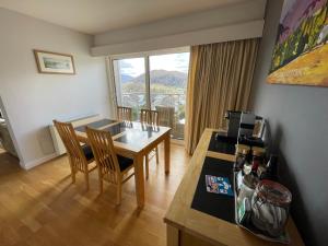 a dining room with a table and chairs and a window at Ambleside 3 Bedroom Apartment in Ambleside