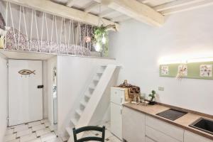 a small kitchen with a staircase in a room at Il Nido di Rio Elba in Rio nellʼElba