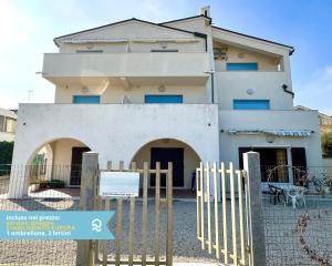a building with a fence in front of it at RS323 - Marcelli, bilocale fronte mare con spiaggia inclusa in Marcelli