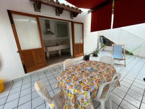 a room with a table and chairs and a room with a fireplace at Il GIARDINO della FALENA in Favignana +19 photos