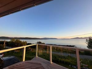a balcony with a view of a body of water at Lenangsvegen 2929 in Russelv