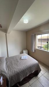 a bedroom with a bed and a window at Campo Palace Hotel in Campo Mourão +6 photos