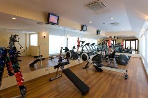 a gym with a mirror and people exercising in it at Latanya Palm Hotel Antalya in Antalya