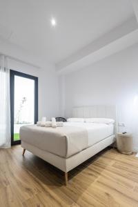 Postel nebo postele na pokoji v ubytování Lôla Suites by Concept Flats