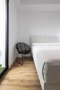 Postel nebo postele na pokoji v ubytování Lôla Suites by Concept Flats