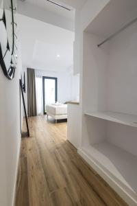 Postel nebo postele na pokoji v ubytování Lôla Suites by Concept Flats
