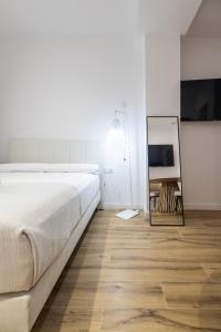 Postel nebo postele na pokoji v ubytování Lôla Suites by Concept Flats