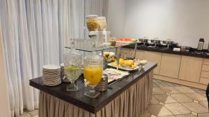 a buffet with glasses of orange juice on a table at Campo Palace Hotel in Campo Mourão