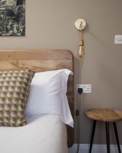 a bedroom with a bed and a lamp and a table at Modern Central one Bedroom Apartment in Penzance in Penzance