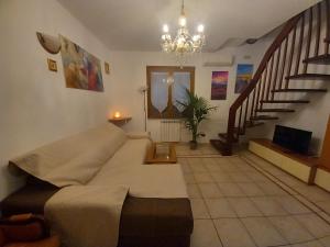 a living room with a couch and a staircase at Villetta Tora in Santo Stefano di Magra