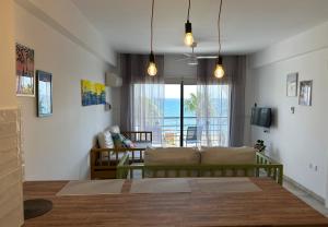 a living room with a couch and a table at Krasas Beach in Larnaca