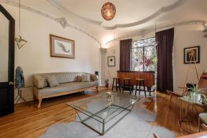 a living room with a couch and a table at Pug Seal Polanco Allan Poe in Mexico City