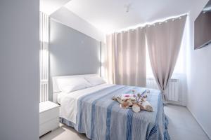 two teddy bears sitting on a bed in a bedroom at Lulu Apartament in Civitanova Marche